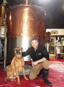 Co-owner and brewmaster Clay Potter, with his dog, Brew, at Moon Under Water