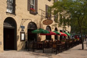 The inviting sidewalk patio offers a European ambiance